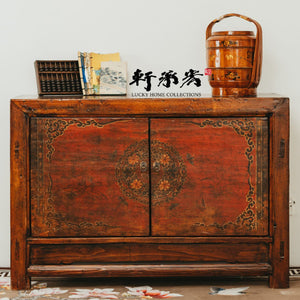 sideboard with worn painting of floral motifs