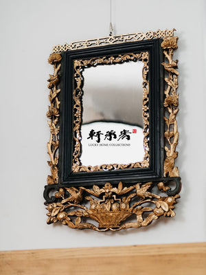 intricately carved framed mirror